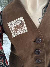 1 of 1 rework upcycled vintage brown leather vest with wool floral paisley sweater sleeves other side embroidery patch details. SÖZ Bazaar Colorado.