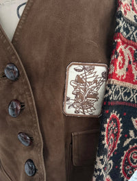 1 of 1 rework upcycled vintage brown leather vest with wool floral paisley sweater sleeves embroidery patch details. SÖZ Bazaar Colorado.